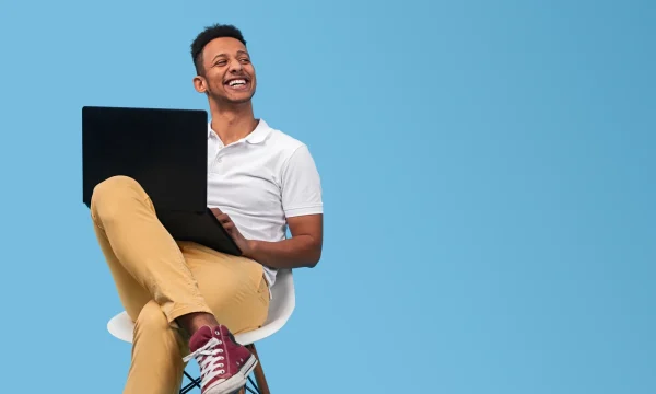 man with laptop sitting on a chair