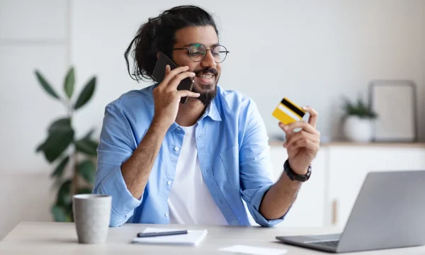 man on phone with credit card