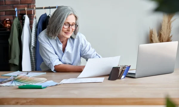 elder woman works on online projects