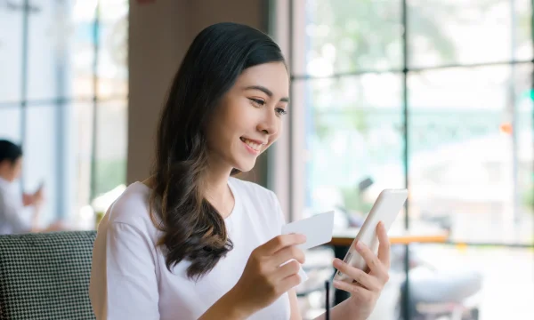 woman making mobile card purchases in public